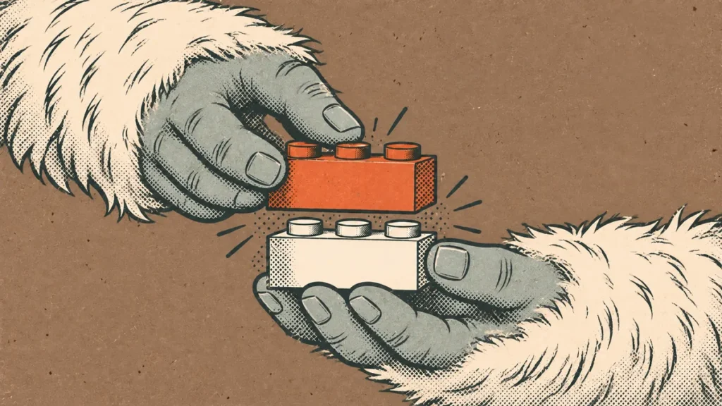 Comic close-up of a yeti’s hands pressing two plain building bricks together