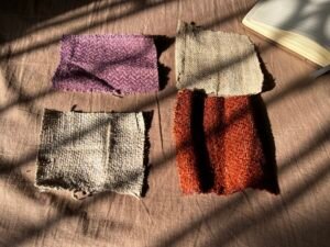 Four handwoven hemp fabric swatches showing different weaves and dye colours.